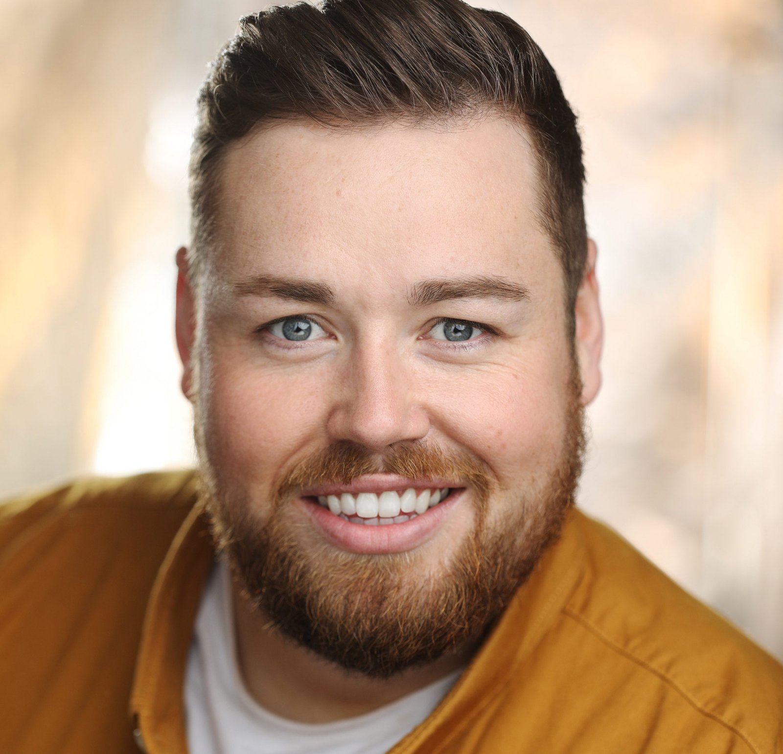 Scott Riney smiling at camera in head shot style portrait ohoto