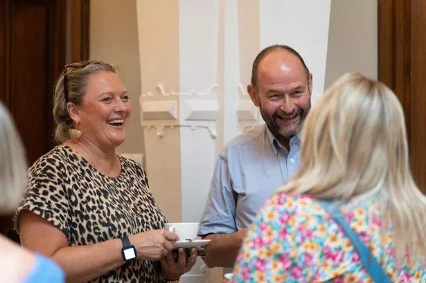 Group of 3 adults at an event laughing