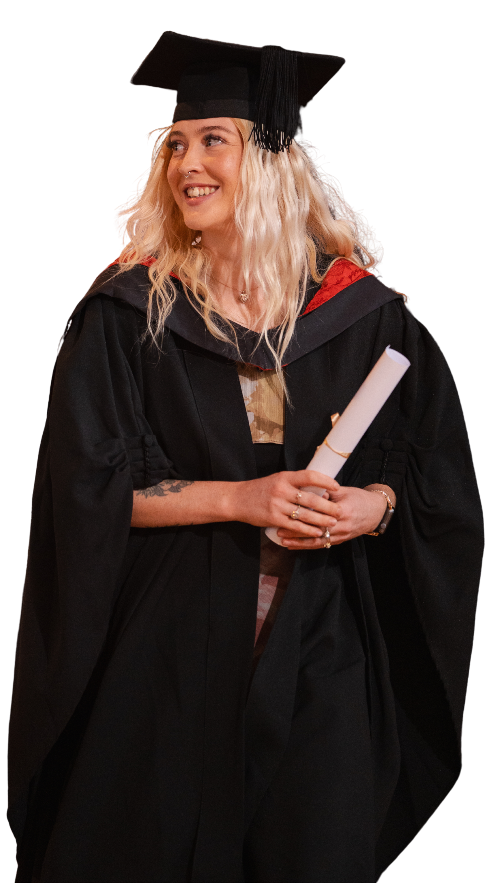 female graduate wearing gown at University Centre Weston holding degree scroll