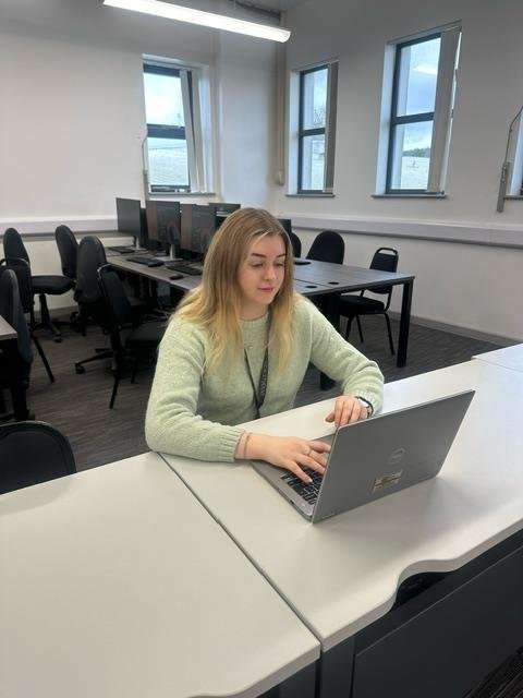 Emma studying in a classroom