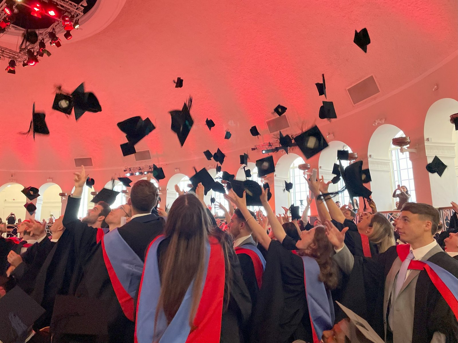 Graduates throwing their hats in the air at Graduation