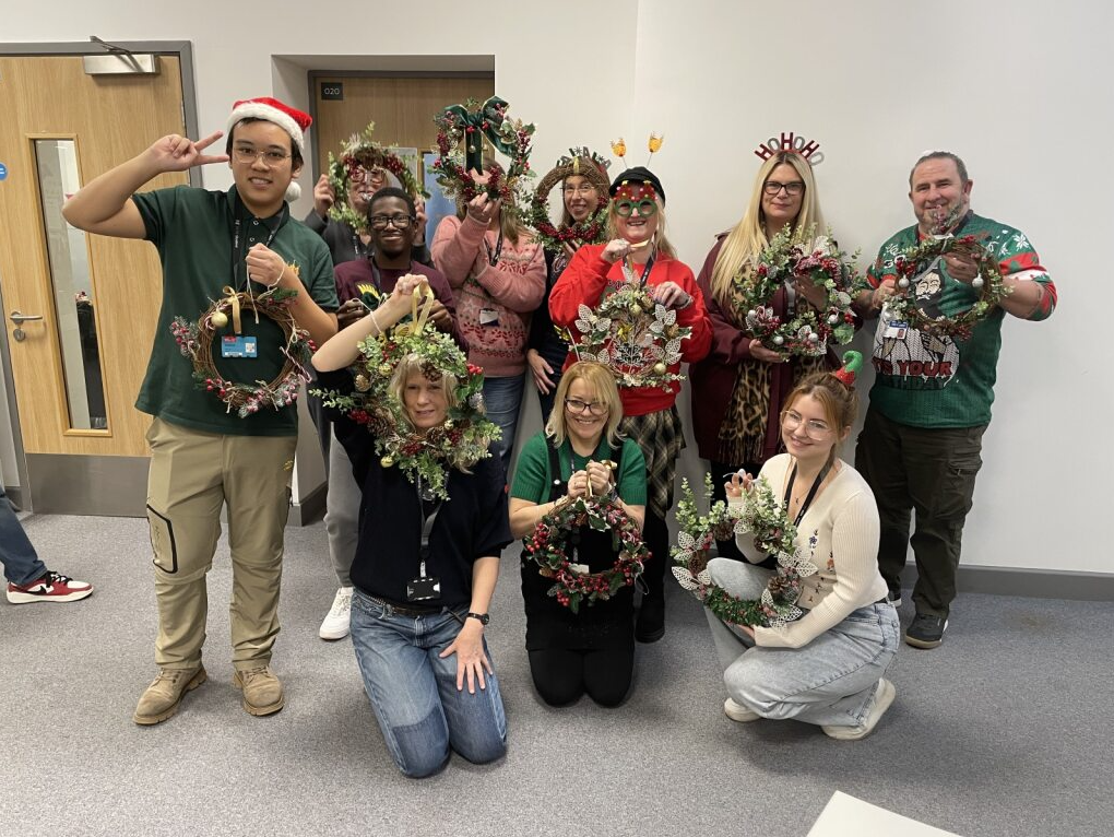 Group picture of students holding their wreaths
